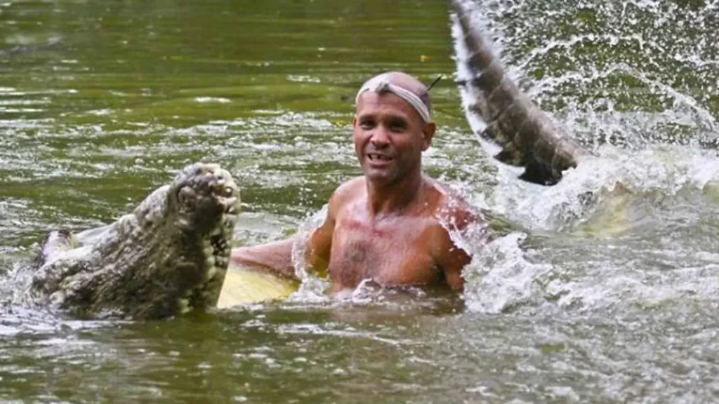 Pocho the crocodile plays with his human friend Gilberto "Chito" Shedden.