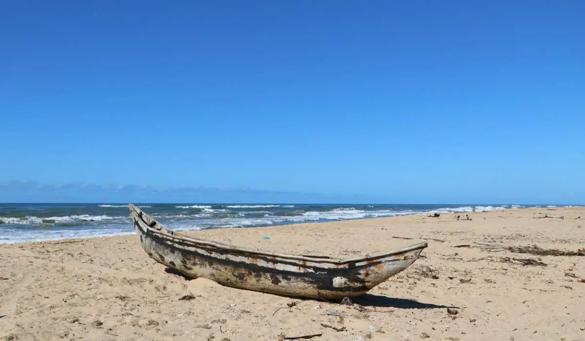 A boat on a sandy beach
