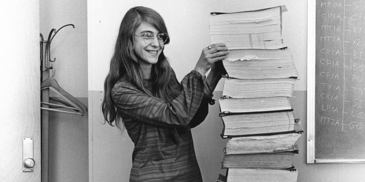 Margaret Hamilton standing next to Apollo 11 Code (cropped image)