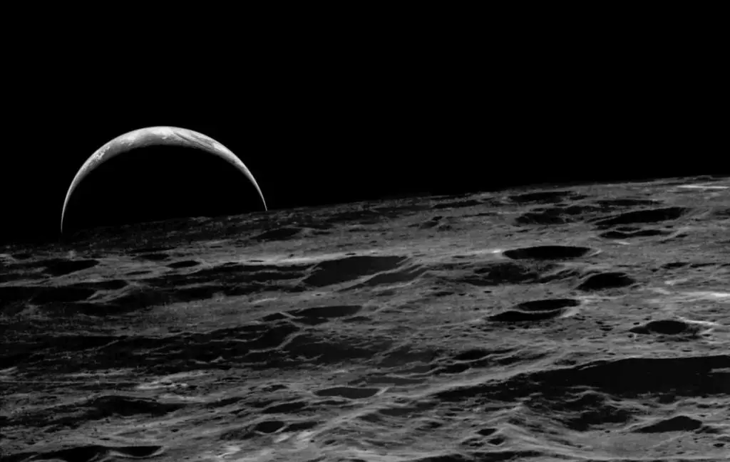 A crescent Earth rising over the Moon