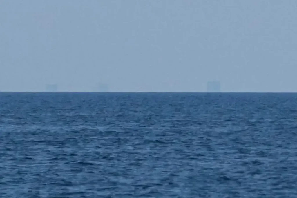 The top of the Boston skyline is just barely visible from Cape Cod, because of the curvature of Earth